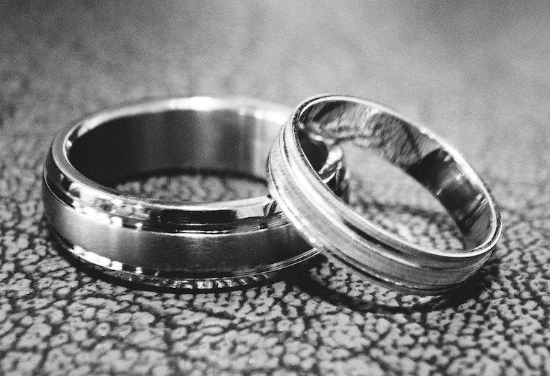 silver wedding rings on a table